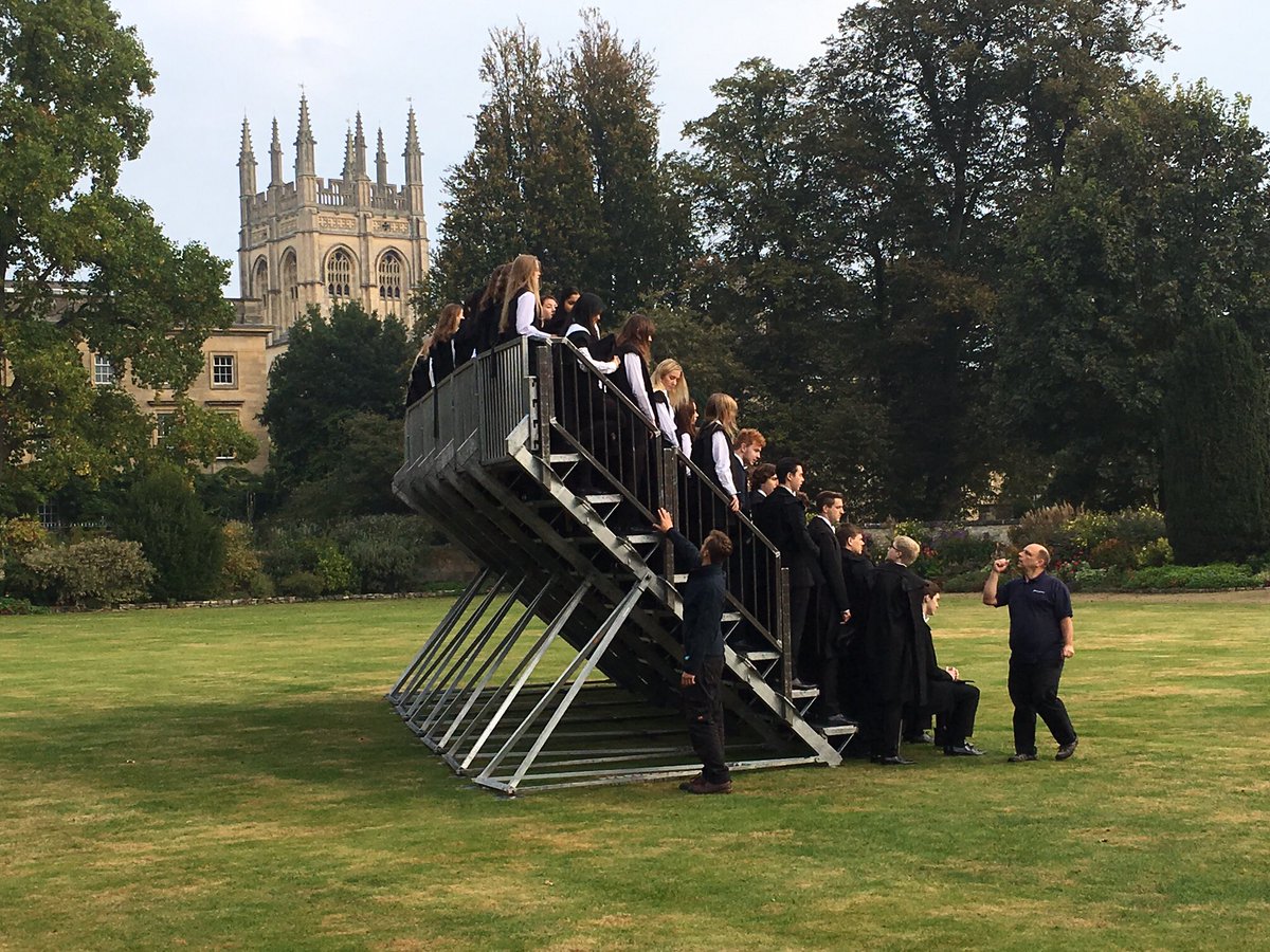 A photographer setting up tiered staging for a large group